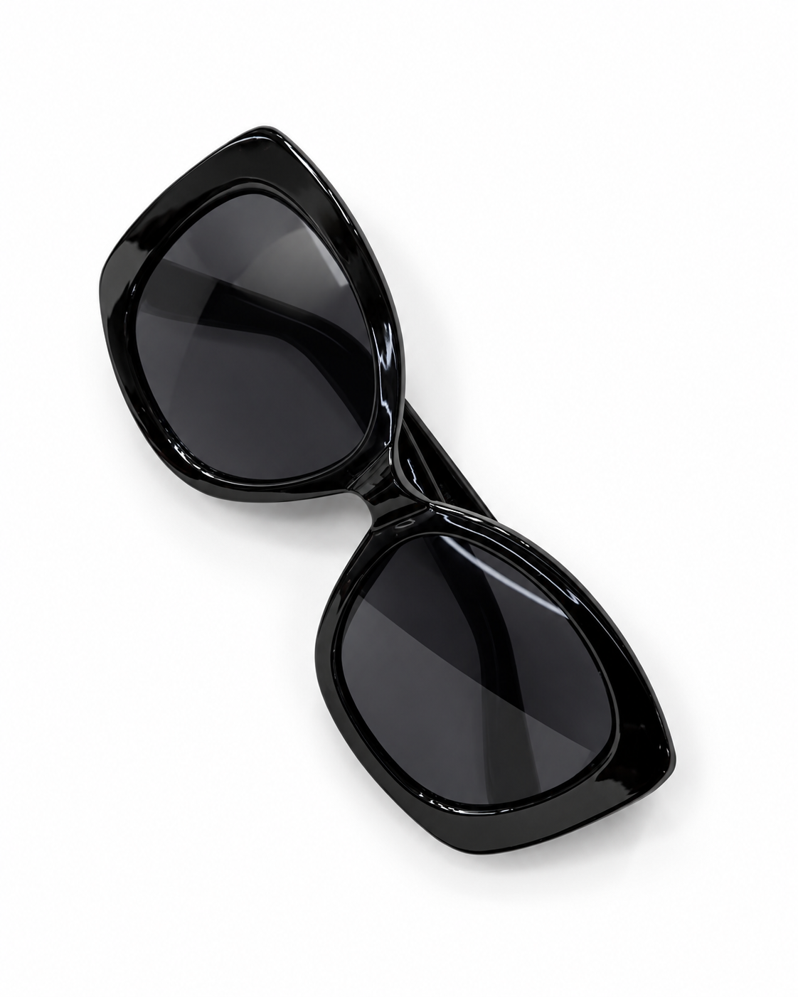 Glossy black oversized geometric sunglasses with dark UV400 lenses, photographed from above.